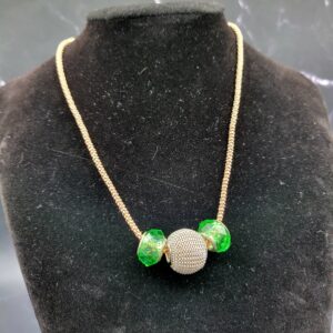 Green crystal on copper chain